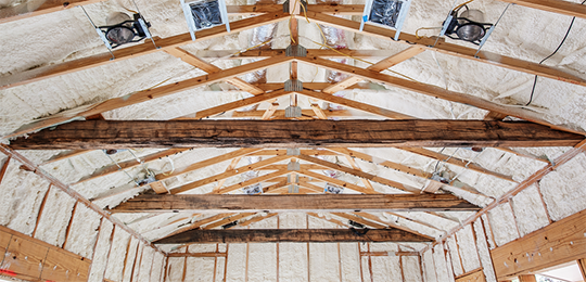 Spray foam insulation installed in an unfinished home's ceiling